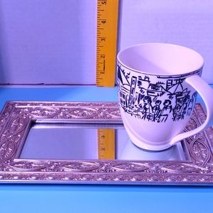 A vintage Mikasa coffee cup paired with a console or a dresser mirror. Both item